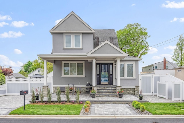 1 3rd Pl, Bellmore, NY 11710 - view of front of house featuring stucco siding, fence, and covered porch