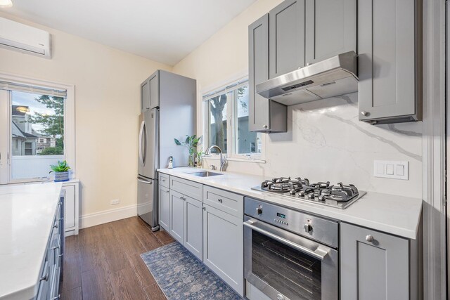 1 3rd Pl, Bellmore, NY 11710 - kitchen featuring stainless steel appliances, a sink, a wall unit AC, and gray cabinetry