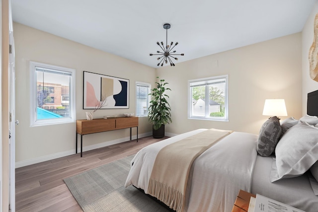1 3rd Pl, Bellmore, NY 11710 - bedroom featuring wood finished floors, baseboards, and a chandelier