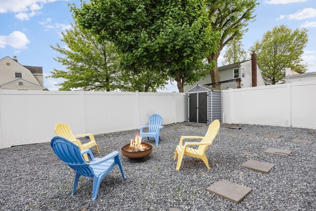 1 3rd Pl, Bellmore, NY 11710 - fenced backyard featuring a fire pit, a shed, and an outdoor structure