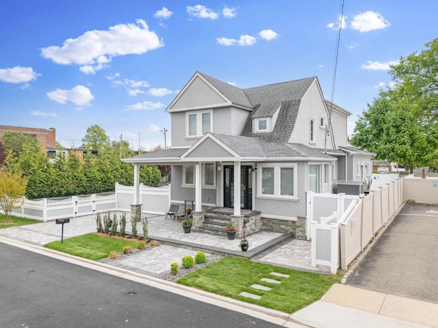 1 3rd Pl, Bellmore, NY 11710 - view of front facade featuring roof with shingles and stucco siding