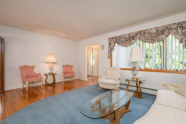 745 Willow Rd, Franklin Square, NY 11010 - living area with a baseboard radiator and wood finished floors
