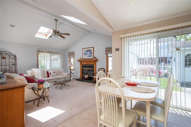 745 Willow Rd, Franklin Square, NY 11010 - dining area with a skylight, healthy amount of natural light, light carpet, a glass covered fireplace, and beamed ceiling