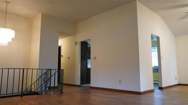 15 Sabra Ln, Wappingers Falls, NY 12590 - empty room with a chandelier, wood finished floors, baseboards, and a baseboard radiator