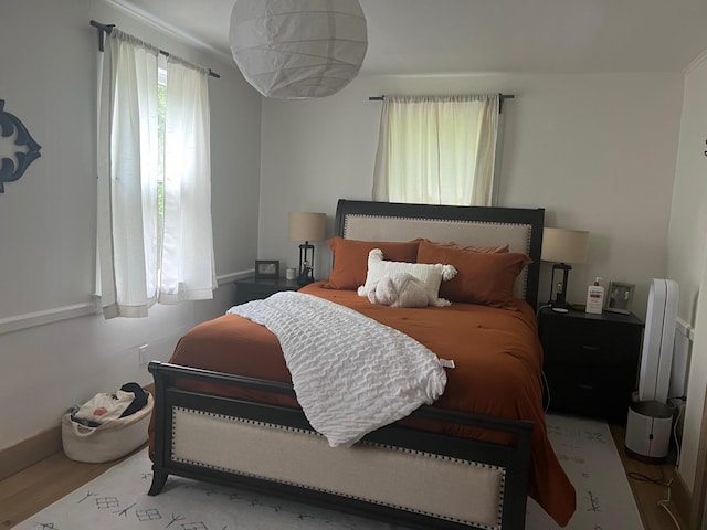 bedroom with baseboards and wood finished floors
