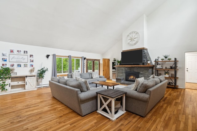 162 Forest Hill Dr, Kingston, NY 12401 - living area with high vaulted ceiling, wood finished floors, a fireplace, and a baseboard radiator