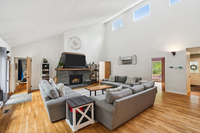 162 Forest Hill Dr, Kingston, NY 12401 - living area featuring high vaulted ceiling, light wood-type flooring, healthy amount of natural light, a fireplace, and baseboards