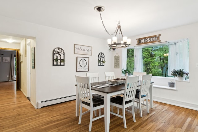 162 Forest Hill Dr, Kingston, NY 12401 - dining room featuring a baseboard radiator, a chandelier, light wood-style floors, and baseboards