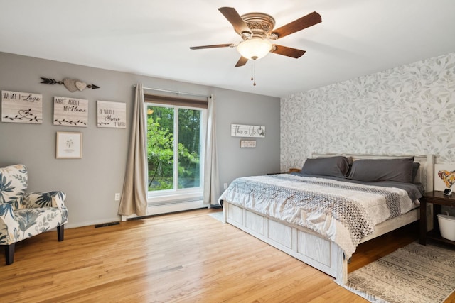 162 Forest Hill Dr, Kingston, NY 12401 - bedroom with wallpapered walls, wood finished floors, and ceiling fan
