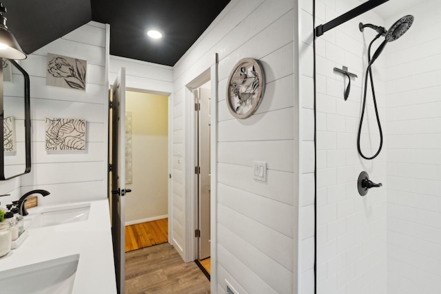 162 Forest Hill Dr, Kingston, NY 12401 - bathroom featuring tiled shower, wood finished floors, recessed lighting, and double vanity