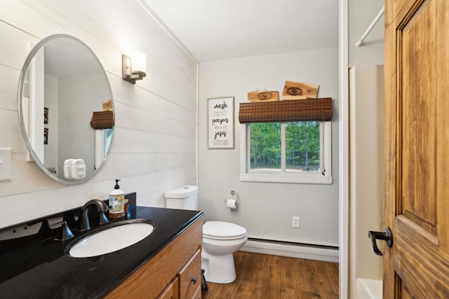 162 Forest Hill Dr, Kingston, NY 12401 - bathroom with a baseboard radiator, toilet, wood finished floors, and vanity