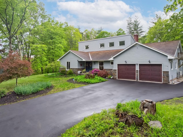 162 Forest Hill Dr, Kingston, NY 12401 - view of front of house featuring stone siding, a garage, driveway, a chimney, and a shingled roof