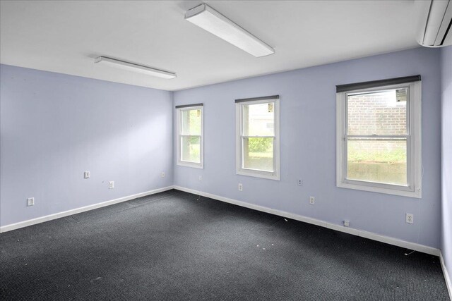 25-31/33 Francis Lewis Blvd, Whitestone, NY 11358 - empty room with an AC wall unit, dark carpet, and baseboards
