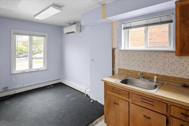 25-31/33 Francis Lewis Blvd, Whitestone, NY 11358 - kitchen featuring an AC wall unit, a sink, light countertops, and brown cabinetry