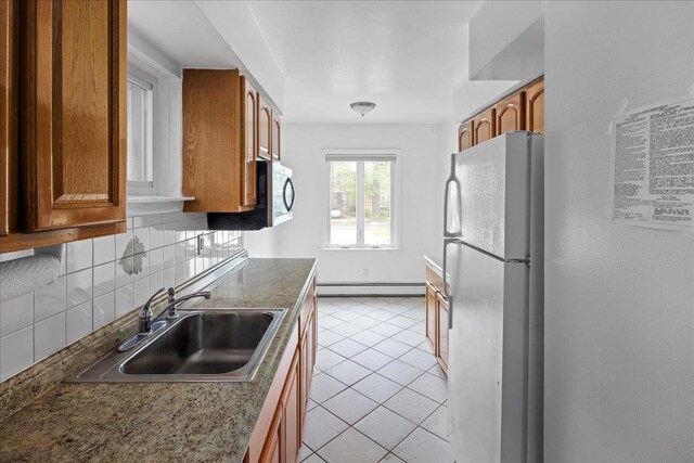 25-31/33 Francis Lewis Blvd, Whitestone, NY 11358 - kitchen featuring freestanding refrigerator, a baseboard heating unit, a sink, and brown cabinets