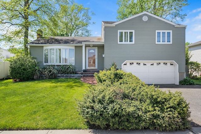 105 Farmers Ave, Plainview, NY 11803 - split level home with a garage, asphalt driveway, a front yard, and a chimney