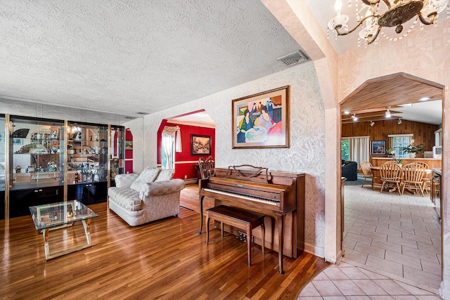 105 Farmers Ave, Plainview, NY 11803 - living area with a chandelier, wood finished floors, and a textured ceiling