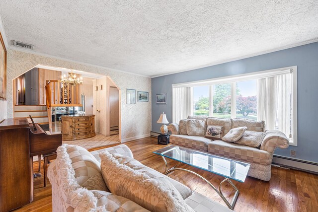 105 Farmers Ave, Plainview, NY 11803 - living room with a chandelier, baseboards, wood-type flooring, a textured ceiling, and wallpapered walls