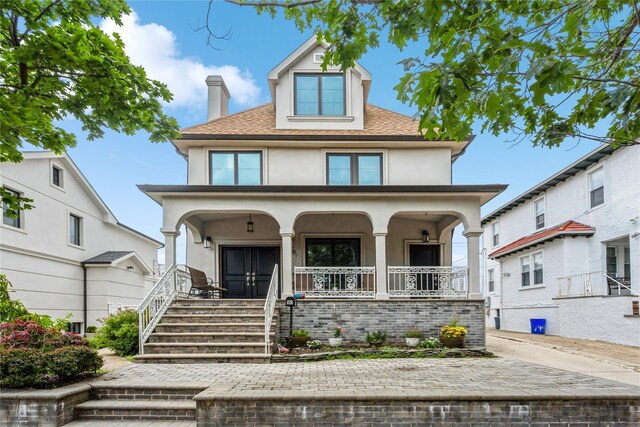 161 W Walnut St, Long Beach, NY 11561 - traditional style home with covered porch, stucco siding, a chimney, roof with shingles, and stairway