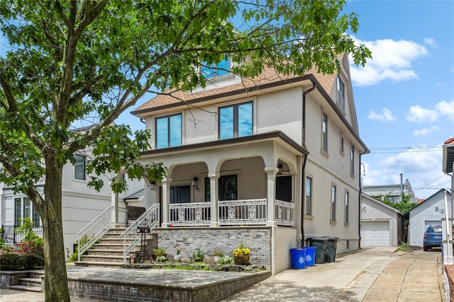 161 W Walnut St, Long Beach, NY 11561 - traditional style home with a porch, stucco siding, an outdoor structure, and a detached garage