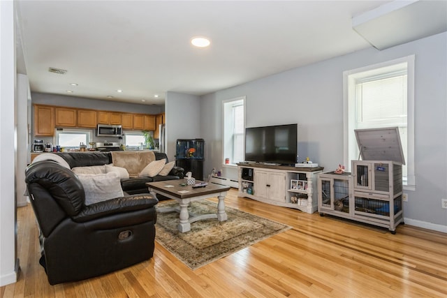 161 W Walnut St, Long Beach, NY 11561 - living room with a baseboard heating unit, light wood finished floors, baseboards, and recessed lighting
