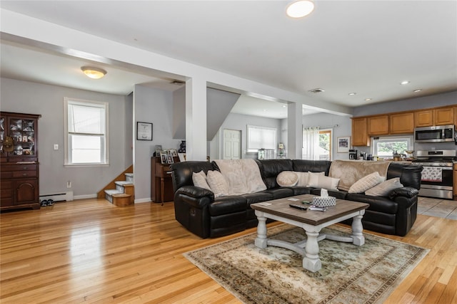 161 W Walnut St, Long Beach, NY 11561 - living area featuring a baseboard heating unit, stairway, plenty of natural light, light wood finished floors, and recessed lighting