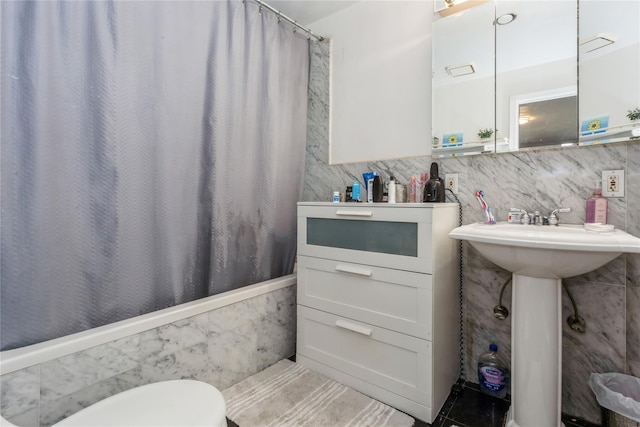 161 W Walnut St, Long Beach, NY 11561 - full bathroom with tile walls, shower / tub combo, toilet, and wainscoting