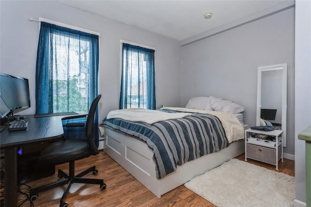 161 W Walnut St, Long Beach, NY 11561 - bedroom with a desk, wood finished floors, and baseboards