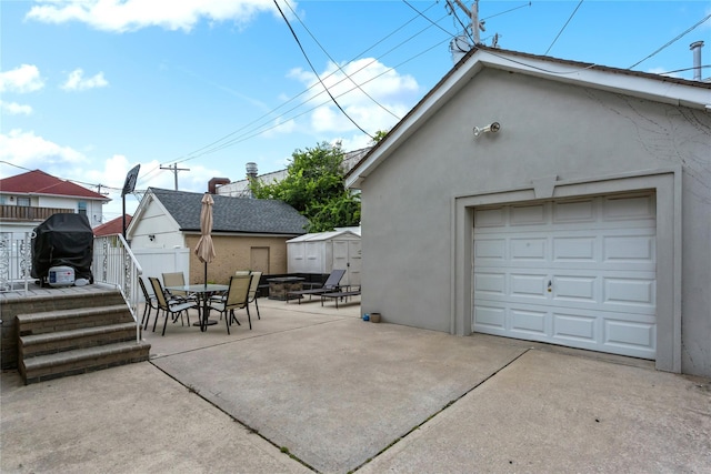 161 W Walnut St, Long Beach, NY 11561 - detached garage featuring concrete driveway and a storage shed