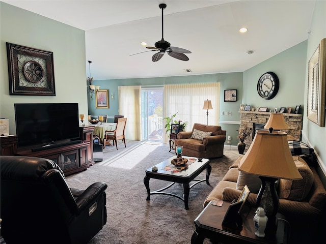 211 Pond Cir, Mount Sinai, NY 11766 - carpeted living area featuring ceiling fan and a fireplace