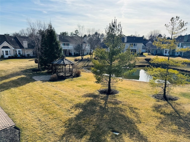 211 Pond Cir, Mount Sinai, NY 11766 - view of grassy yard featuring a gazebo, a residential view, and a water view