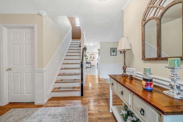8 Emerald Ct, Moriches, NY 11955 - stairs featuring a wainscoted wall, wood finished floors, and ornamental molding