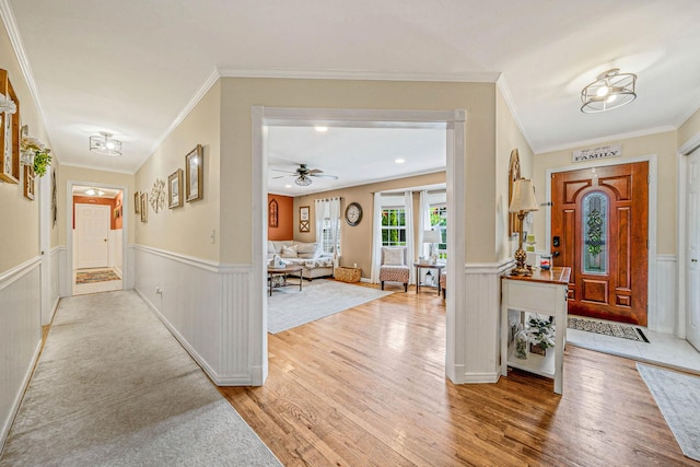 8 Emerald Ct, Moriches, NY 11955 - foyer entrance featuring wainscoting, wood finished floors, ornamental molding, and ceiling fan