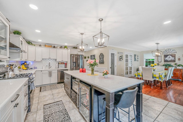 8 Emerald Ct, Moriches, NY 11955 - kitchen with appliances with stainless steel finishes, beverage cooler, a chandelier, a sink, and recessed lighting