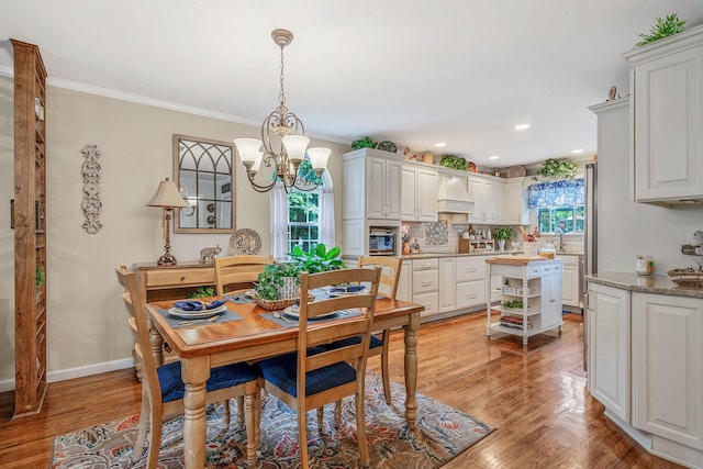8 Emerald Ct, Moriches, NY 11955 - dining area featuring a chandelier, ornamental molding, light wood finished floors, baseboards, and recessed lighting