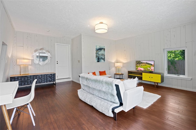 55 W End Ave, East Quogue, NY 11942 - living area with wood-type flooring, a textured ceiling, wooden walls, and baseboards