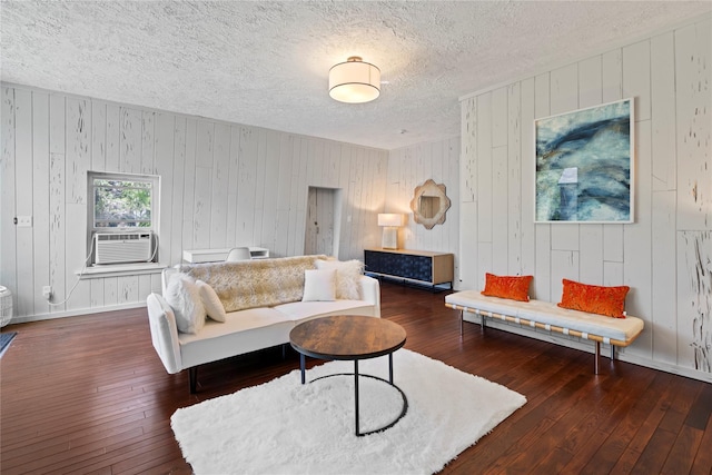 55 W End Ave, East Quogue, NY 11942 - living room with cooling unit, wood-type flooring, a textured ceiling, wooden walls, and baseboards