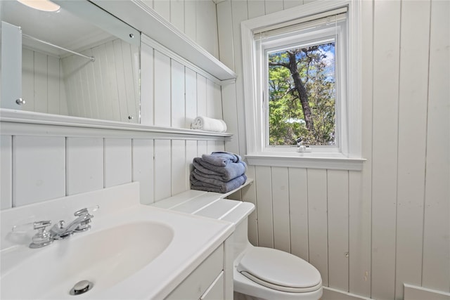 55 W End Ave, East Quogue, NY 11942 - bathroom with toilet, wooden walls, and vanity