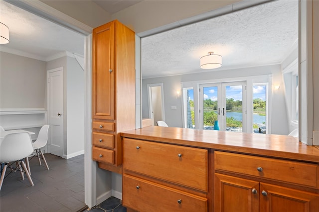 55 W End Ave, East Quogue, NY 11942 - kitchen featuring ornamental molding, french doors, brown cabinets, and baseboards