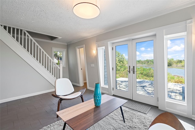 55 W End Ave, East Quogue, NY 11942 - living area featuring a textured ceiling, healthy amount of natural light, stairway, french doors, and a water view