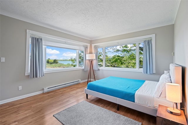 55 W End Ave, East Quogue, NY 11942 - bedroom featuring a baseboard heating unit, multiple windows, ornamental molding, a textured ceiling, and wood finished floors