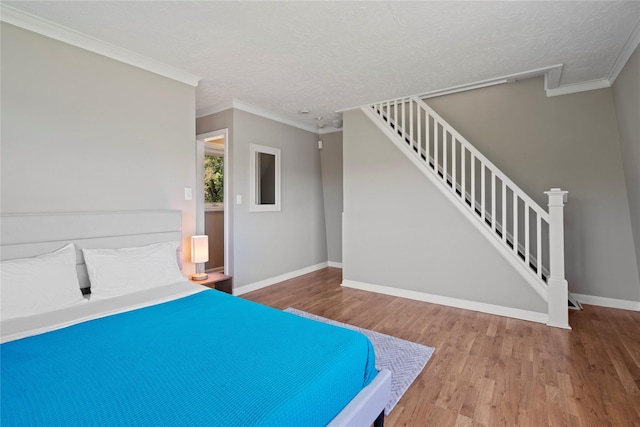 55 W End Ave, East Quogue, NY 11942 - unfurnished bedroom with wood finished floors, baseboards, a textured ceiling, and crown molding