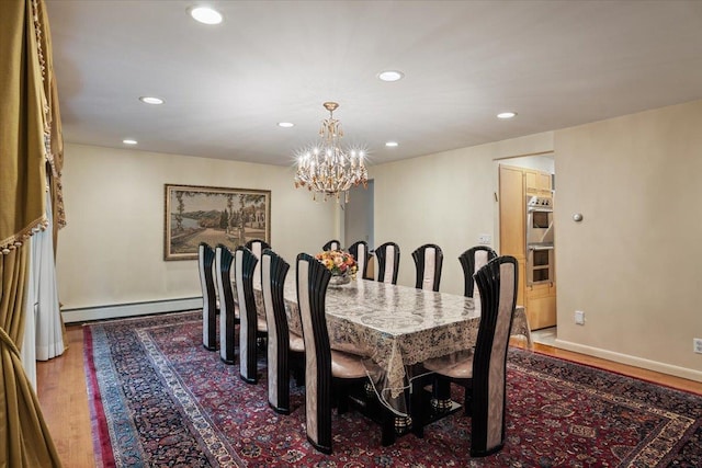 29 Sunset Rd S, Albertson, NY 11507 - dining space with baseboard heating, wood finished floors, a chandelier, recessed lighting, and baseboards