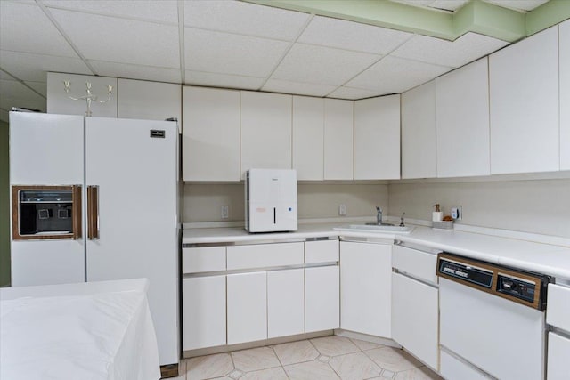 29 Sunset Rd S, Albertson, NY 11507 - kitchen featuring white appliances, a paneled ceiling, white cabinets, light countertops, and a sink