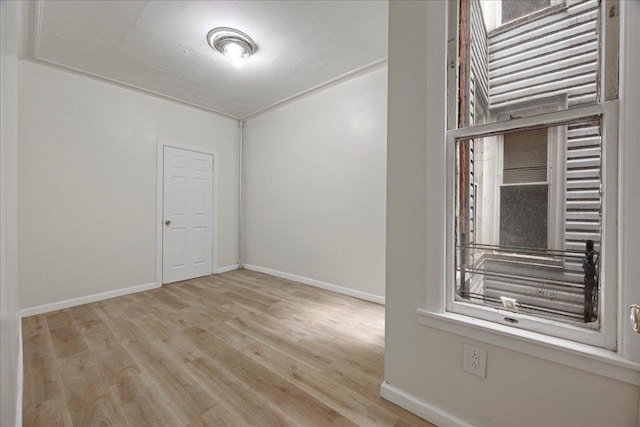 unfurnished room featuring baseboards and wood finished floors