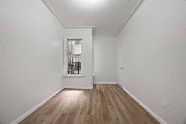 empty room with wood finished floors and baseboards