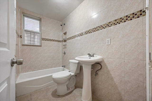 bathroom with tile walls, toilet, shower / bath combination, and tile patterned flooring