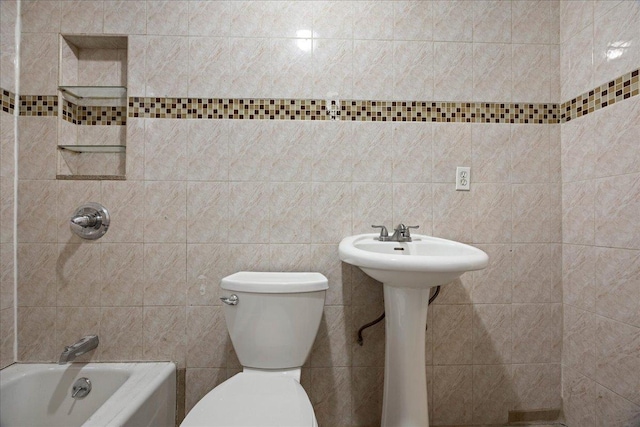 full bathroom featuring toilet and tile walls