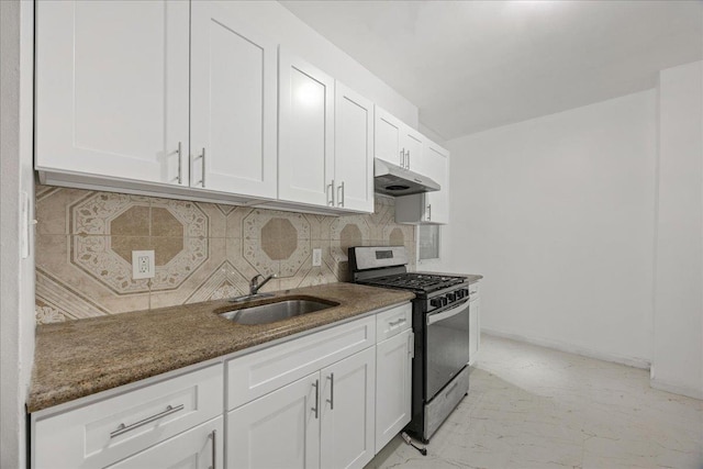 kitchen with stainless steel gas range, a sink, under cabinet range hood, backsplash, and white cabinets