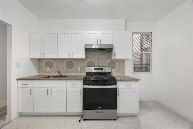 kitchen with stainless steel range with gas stovetop, under cabinet range hood, baseboards, and light marble finish floors